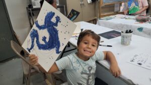 Child holding up painting he made